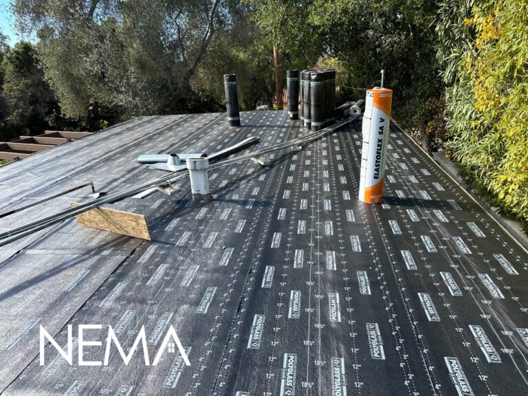 Roof deck covered with synthetic underlayment, with vents and pipe flashings in place