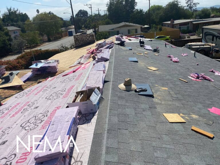 New asphalt shingles going on over underlayment during a roof replacement