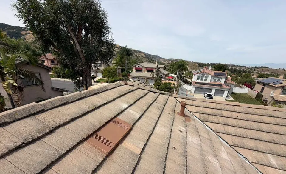 Concrete tile reinstalled in straight courses with a new roof vent after a tile roof re-deck in Corona